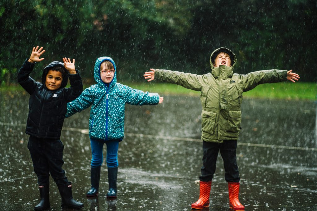 Children playing in the rain