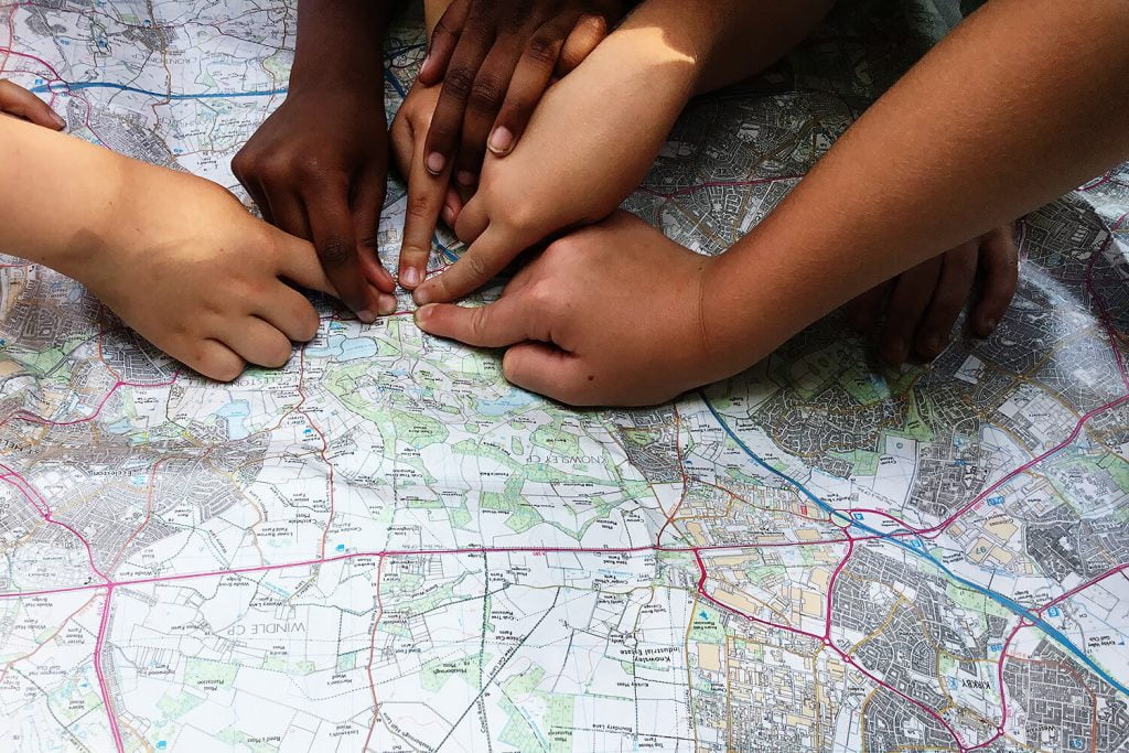 Primary school pupils locating their school on a map during an activity for the My School My Planet project in the North West of England.