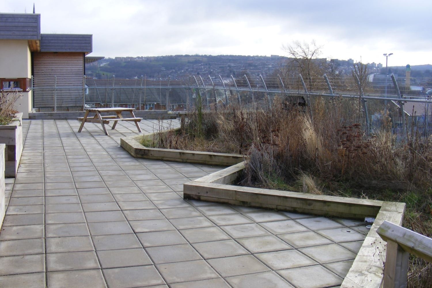 A paved roof planted with green areas to reduce run off from rain in climate ready school grounds.