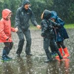 Carley Sefton plays in the rain with a group of children